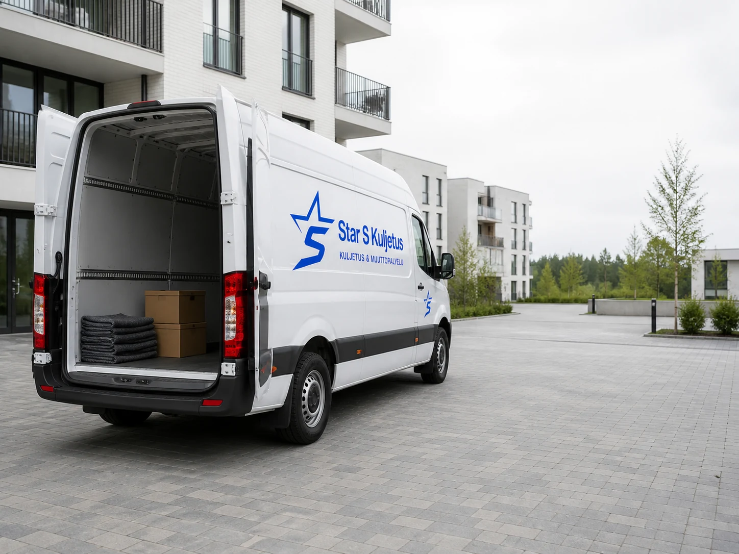 Moving van with rear doors open, boxes and moving blankets inside